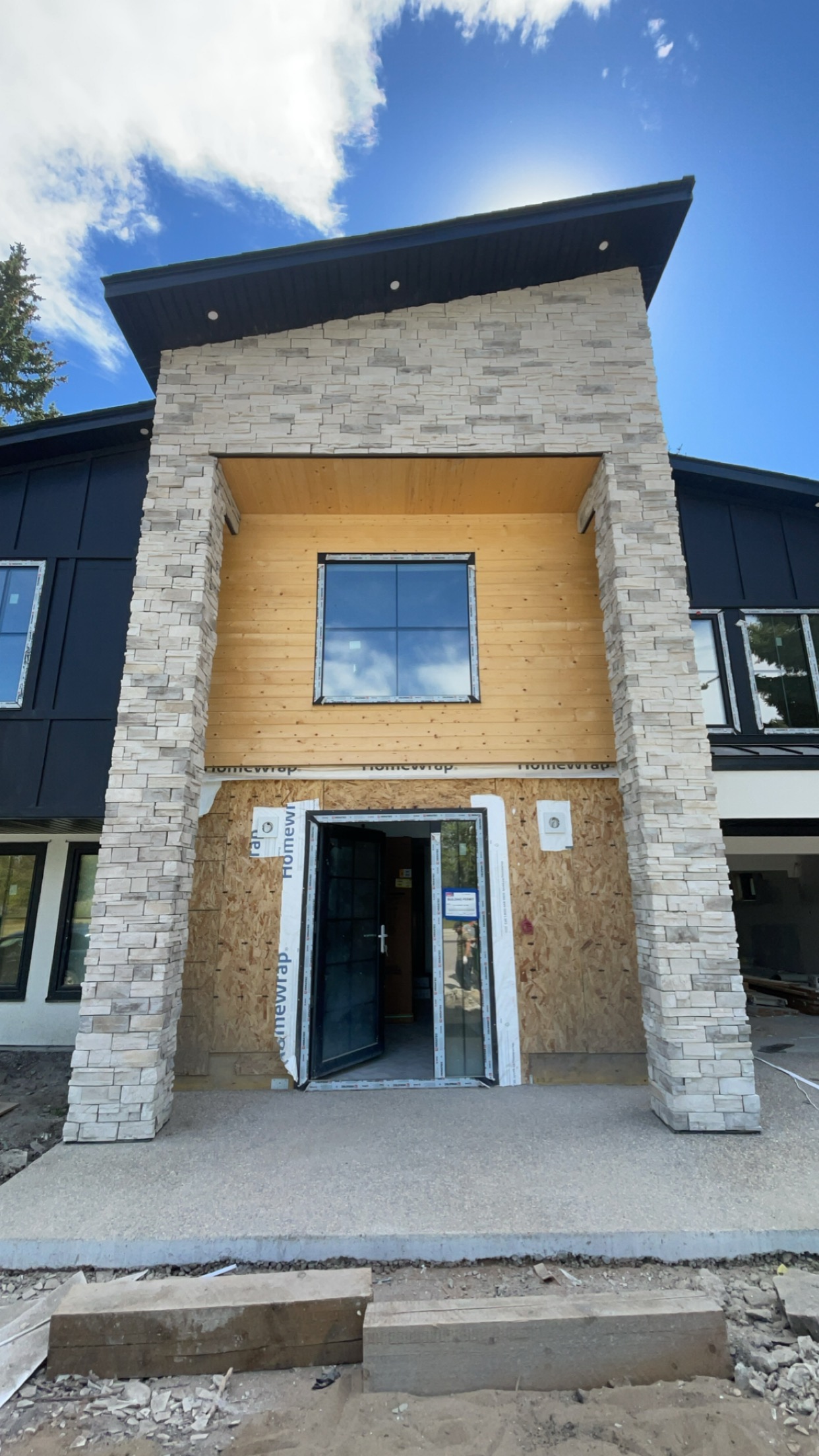 Two-storey stone columns flanking a custom home entry