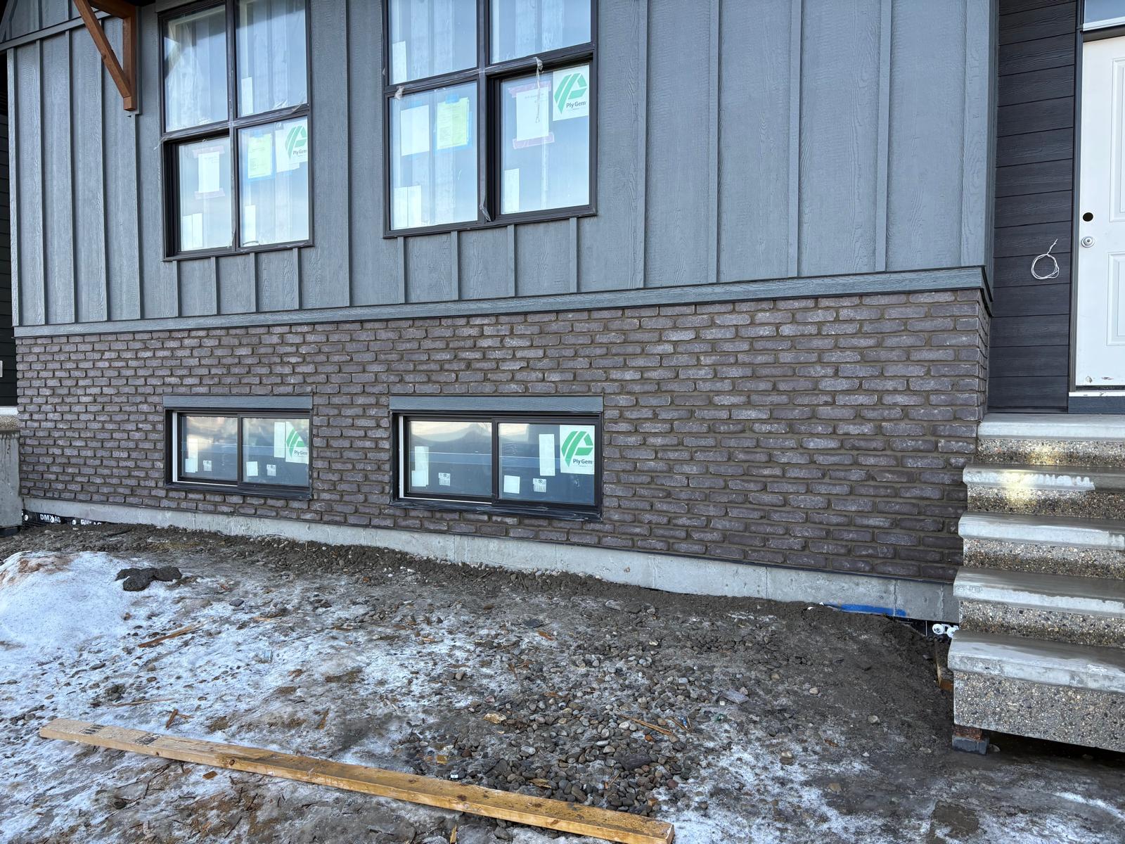 Brick veneer wraparound on a contemporary home foundation